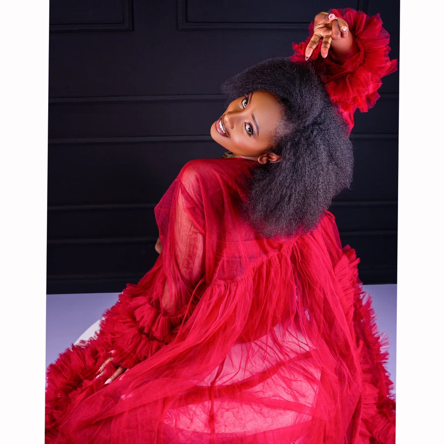 Studio fashion portrait in a red gown