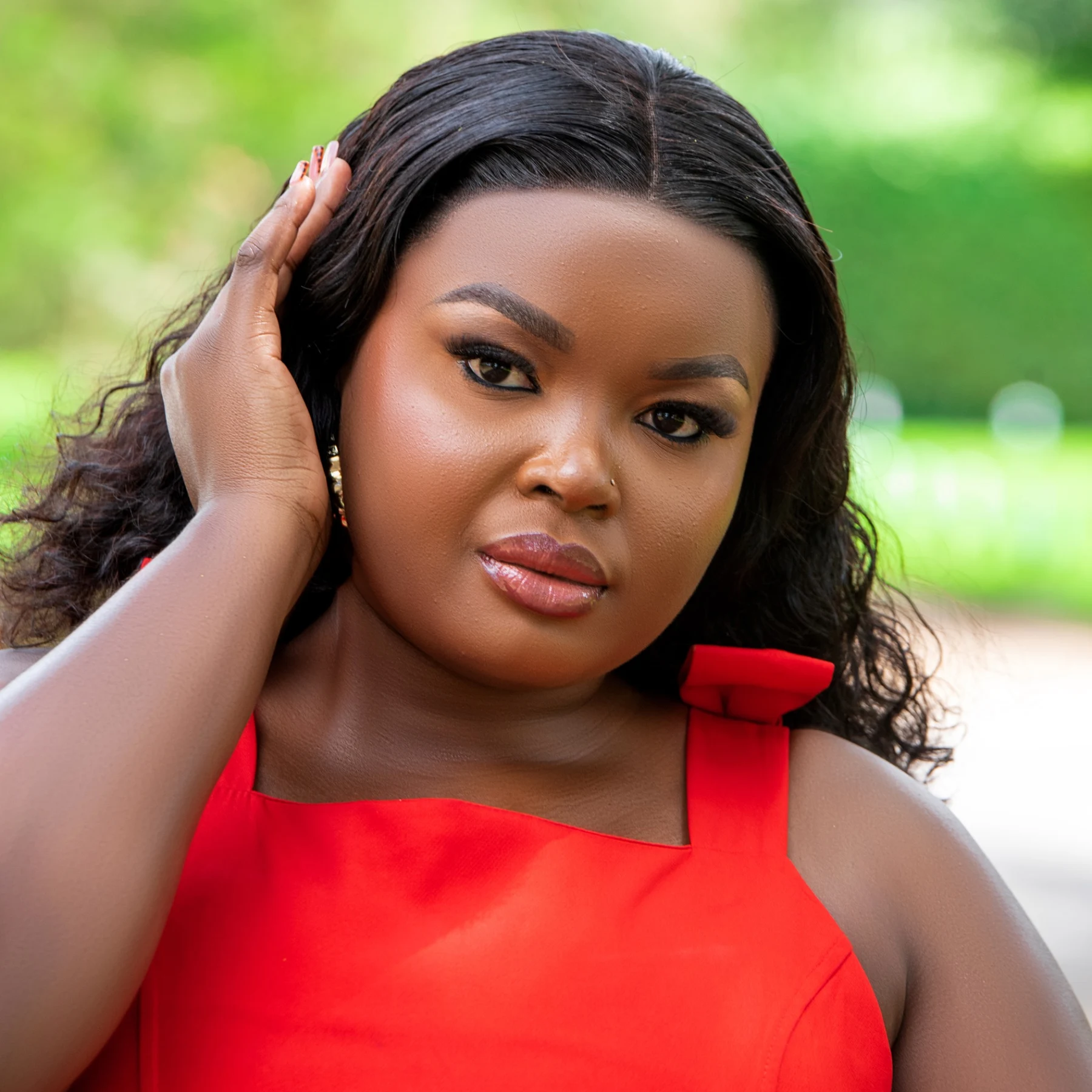 Outdoor beauty portrait of a woman in a red dress